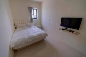 TV i/ili multimedijalni sistem u objektu Xinghai Seaview Guesthouse