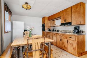 a kitchen with wooden cabinets and a wooden table at Fishing-Spider Lake-Pontoon Rental-Family Friendly in Traverse City +36 photos