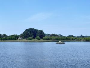 a lake with a small island in the middle of it at Appartement Salines 46m2 in Carnac
