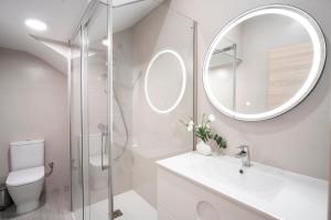 łazienka z toaletą, umywalką i lustrem w obiekcie Apartamentos Marina Playa en 1º línea junto al mar w mieście Rincón de la Victoria +62 zdjęcia