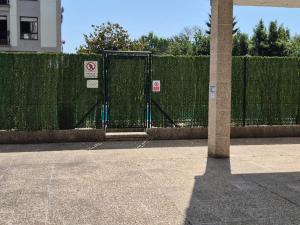 a fence with a gate in front of a building at Alfonso X Lucus Confort in Lugo