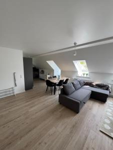 a living room with a couch and a table at New Exclusive 5 bedroom house for 8 persons - 155m2 in Marslev