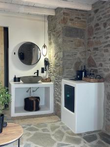 a bathroom with a sink and a mirror at Darsi suites Kythnos in Kithnos +118 photos