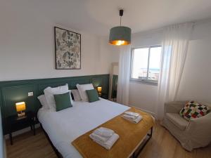 a bedroom with a large bed and a couch at le contemporain in Bastia