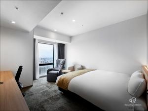 Postel nebo postele na pokoji v ubytování Daiwa Roynet Hotel Omiya-nishiguchi