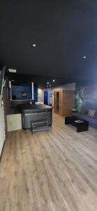 a large room with a piano in a room at American spa motel in Joncherey