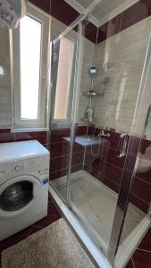 a bathroom with a shower and a washing machine at BLUE MOON in Sarajevo +27 photos