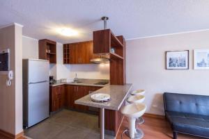 a kitchen with a refrigerator and a counter top at Ocean View Beautiful Aparment in Lima