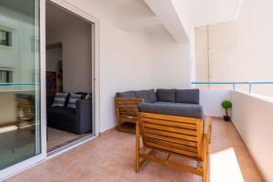 a living room with a couch and a chair at Stylish 2BR Apartment with Rooftop Pool in Mackenzie in Larnaca