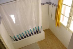 a bathroom with a shower with a shower curtain at Residencial Luz in Tomar