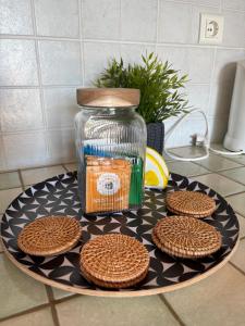a plate with cookies and a jar on a counter at Apartment Blue Bay in Malinska