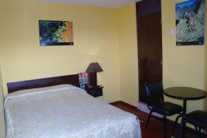 Cama ou camas em um quarto em Hostal Iquique