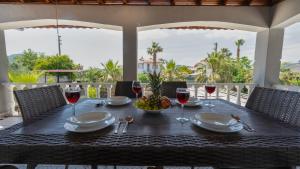 a table with glasses of wine and a bowl of fruit at Villa Gunes in Fethiye