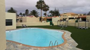 a large swimming pool in the middle of a resort at Casa Marika in Costa Calma