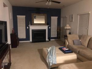 a living room with a couch and a fireplace at 4BR Home close to DUKE & RDU in Durham