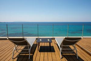 a table and two chairs on the deck of a cruise ship at Hotel Punta Tipa in Trapani