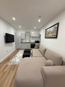 a living room with a couch and a kitchen at Luxury Sovereign House in Brighouse +35 photos