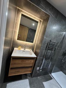 a bathroom with a sink and a shower at Luxury Sovereign House in Brighouse +37 photos