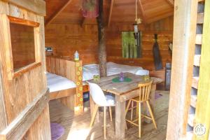 a room with a table and a bed in a cabin at Le Mas des Pins in Beynes +44 photos