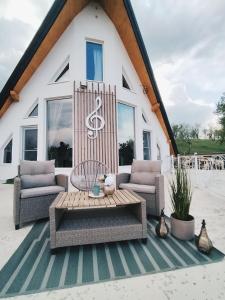 a patio with two chairs and a table at Villa Stradivaryus in Sighetu Marmaţiei