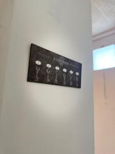 a sign on a wall with a group of keys at Casa Thiaza - Close to Orly - 6 people - 3 bedrooms in Thiais