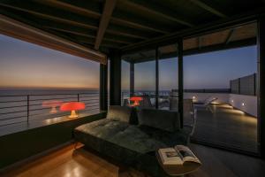 a living room with a couch and a view of the ocean at Hotel Punta Tipa in Trapani