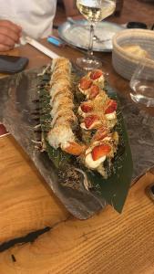 a plate of food on a wooden table at Sol & Sea Apartments in Shëngjin