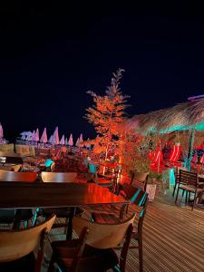 a group of tables and chairs on a deck at night at Sol & Sea Apartments 2 in Shëngjin