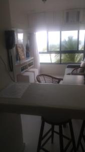 a room with chairs and a table and a phone at Apart Hotel de Ondina in Salvador