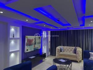 a living room with a couch and blue lighting at Golden tulip in Lagos