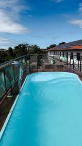 a large blue swimming pool with a water slide at Rede Andrade Rio Branco in Rio Branco