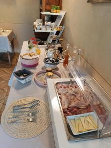 a buffet line with food on a table at B&B La Quercia in Moncalvo
