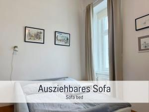 a bedroom with a bed with three pictures on the wall at Salzkammergut Homes Gmunden - Suite Marie Antoinette, Blick auf den Stadtplatz, Traunseeblick - ideal für Paare und Kulturinteressierte in Gmunden