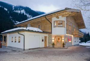 una casa con un garage nella neve di Appartement Wimreiter a Saalbach Hinterglemm