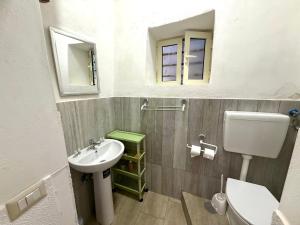a bathroom with a sink and a toilet and a mirror at Al Castello - UN LETTO IDEALE in Gaeta +20 photos
