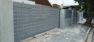 a privacy fence in front of a house at PEACEFUL SLEEP lodge 1 in Goodwood