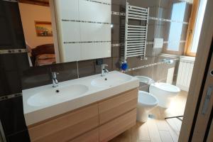 a bathroom with a sink and a toilet at Residenza S anna in Rocca Cilento