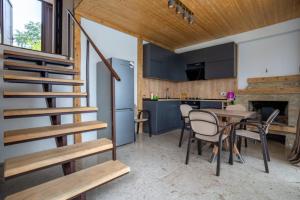 a kitchen and dining room with a staircase in a house at Villa Belvedere in Ambrolauri