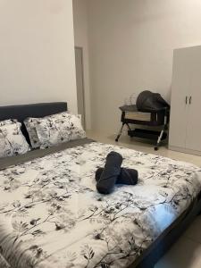 a stuffed animal laying on a bed in a bedroom at DNikayla Homestay in Jitra