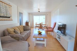 a living room with a couch and a table at L'Escale by Tranquil at Home in Pornichet