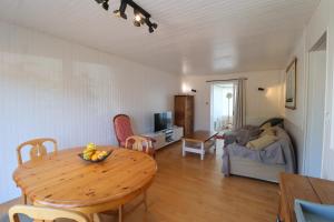 a living room with a wooden table and a dining room at L'Escale by Tranquil at Home in Pornichet