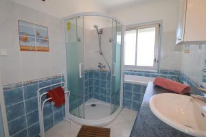 a bathroom with a shower and a sink at L'Escale by Tranquil at Home in Pornichet +9 photos