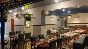 a restaurant with tables and chairs in a room at The Dritan in Bengaluru