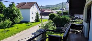 a balcony with a bench and a view of a yard at House Zaterini in Korenica