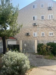 a large brick building with a garage at Daniele Garden in Dubrovnik