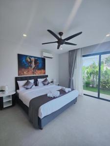 a bedroom with a large bed with a ceiling fan at Samui Luxury villas -By Samui Rental Villas in Nathon Bay +69 photos