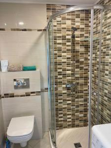 a bathroom with a shower and a toilet at Byla Sea side Apartament in Byala +17 photos