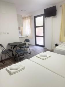 a room with a table and chairs and a kitchen at TIKI Apartments in Gevgelija