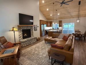 a living room with a couch and a fireplace at 56 Black Bear Bungalow in North Wawona