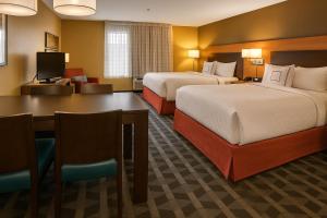a hotel room with two beds and a table at TownePlace Suites by Marriott Hattiesburg in Hattiesburg